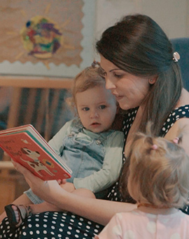 daycare teacher reading to a child