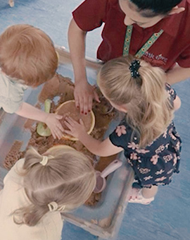 nursery staff playing with children